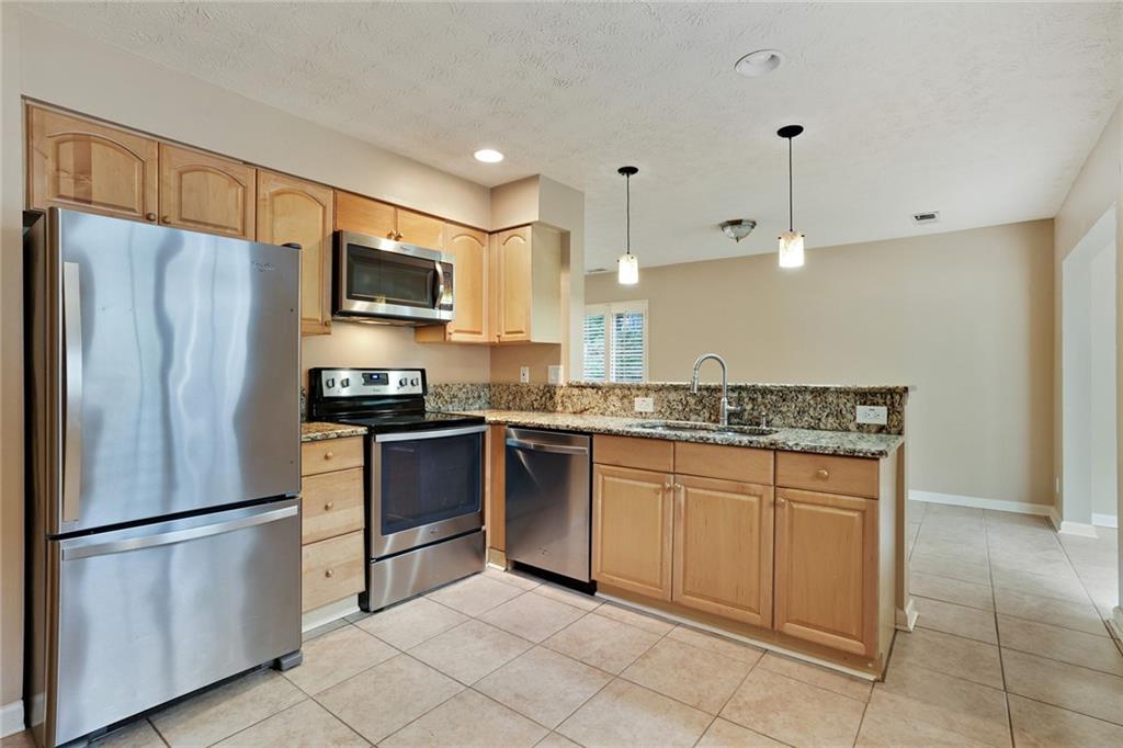 2949 Torreya Way Southeast Marietta, GA 30067 - Photo 9 of 23 a kitchen with stainless steel appliances granite countertop a refrigerator sink and stove