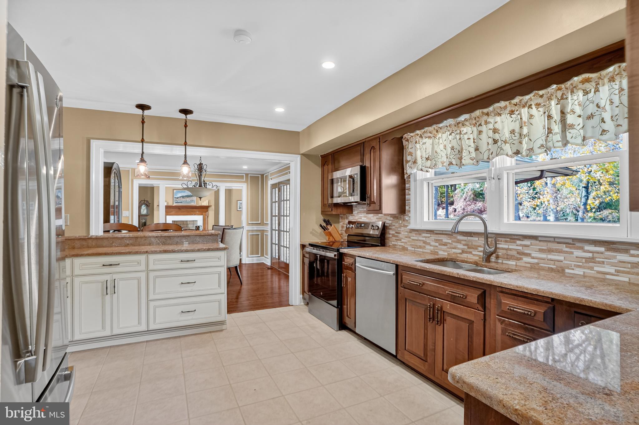 1013 Glen Road Wallingford, PA 19086 - Photo 29 of 45 a kitchen with stainless steel appliances granite countertop a stove and a sink