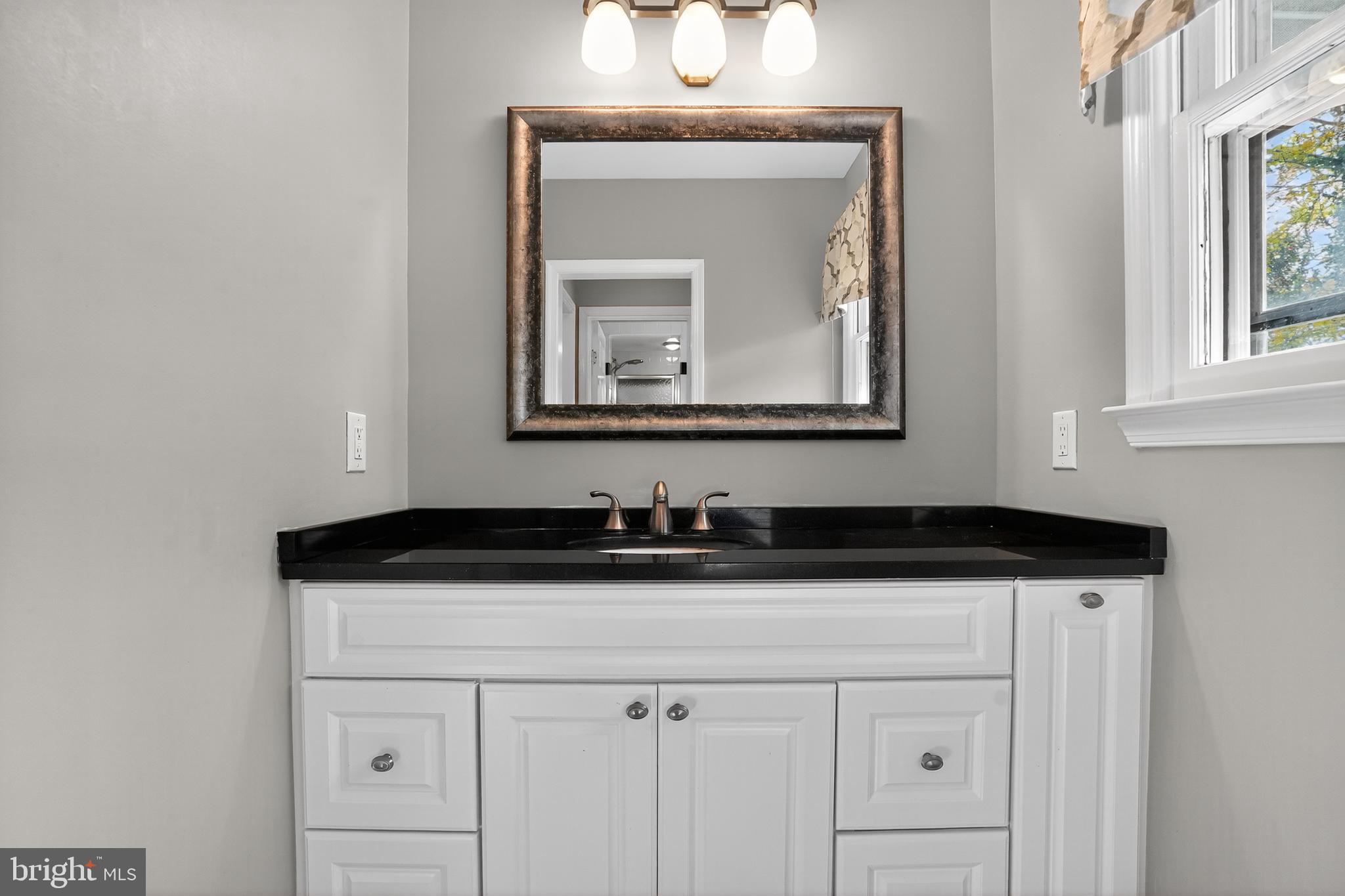 1013 Glen Road Wallingford, PA 19086 - Photo 42 of 45 a bathroom with a sink and a mirror