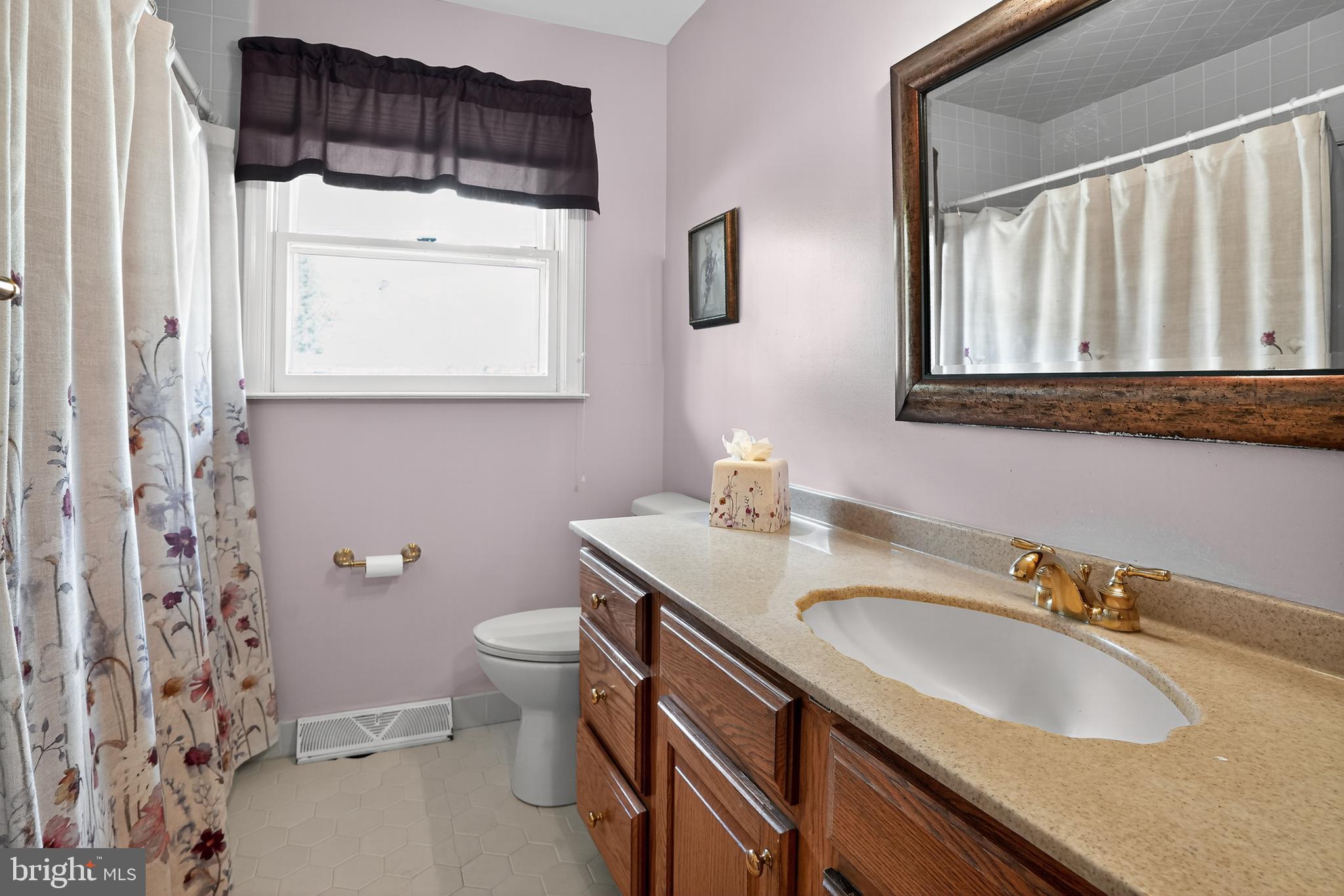 1013 Glen Road Wallingford, PA 19086 - Photo 43 of 45 a bathroom with a granite countertop sink and a toilet