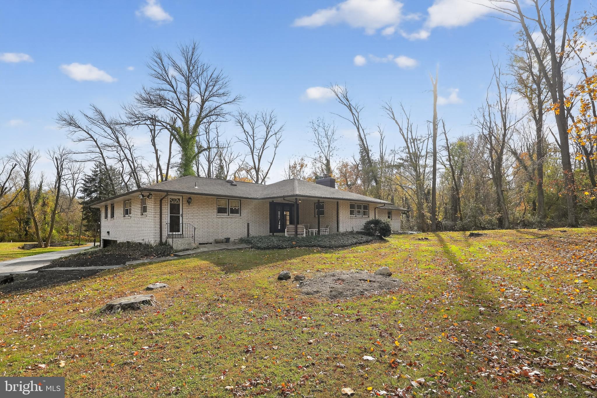 1013 Glen Road Wallingford, PA 19086 - Photo 8 of 45 a front view of a house with a yard and palm trees