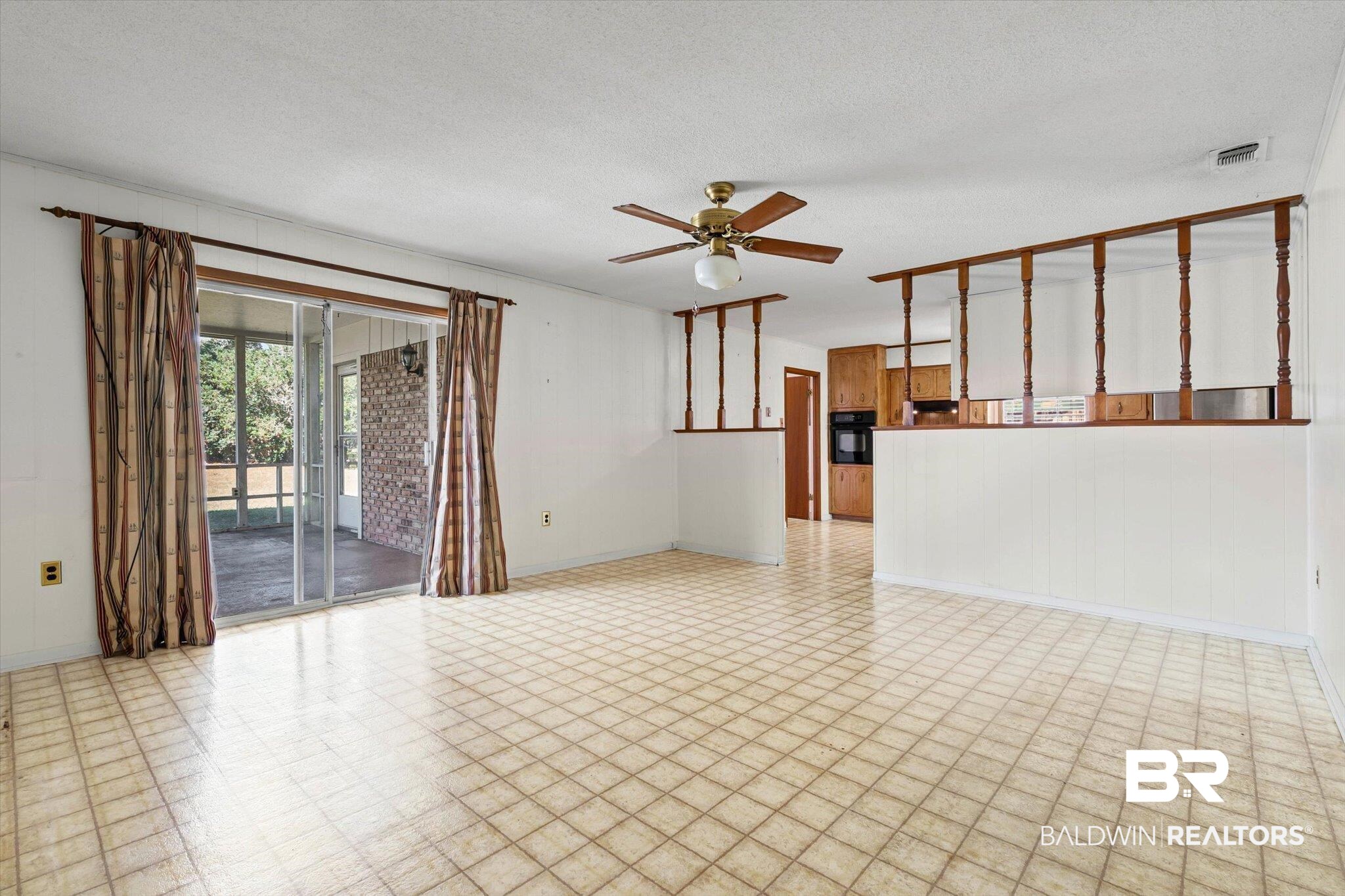 6300 Christopher Drive North Mobile, AL 36609 - Photo 9 of 22 Spare room with a textured ceiling, ceiling fan, and light flooring