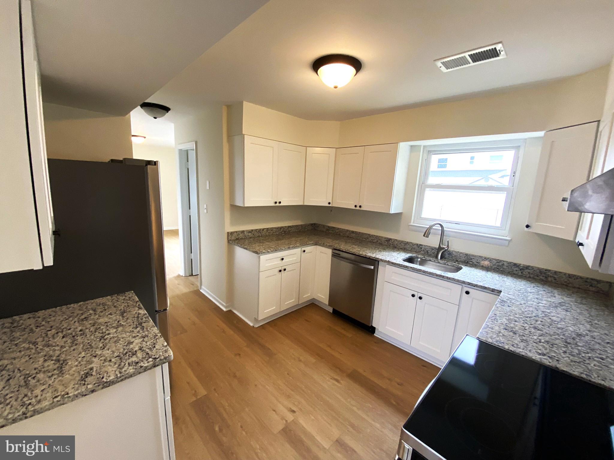 7707 Queens Road Pasadena, MD 21122 - Photo 10 of 19 Bright and inviting modern kitchen.