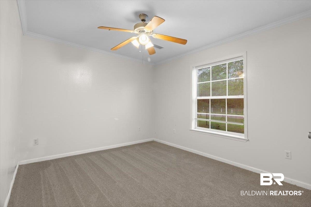 6971 March Road Theodore, AL 36582 - Photo 12 of 26 Unfurnished room with baseboards, crown molding, and carpet floors