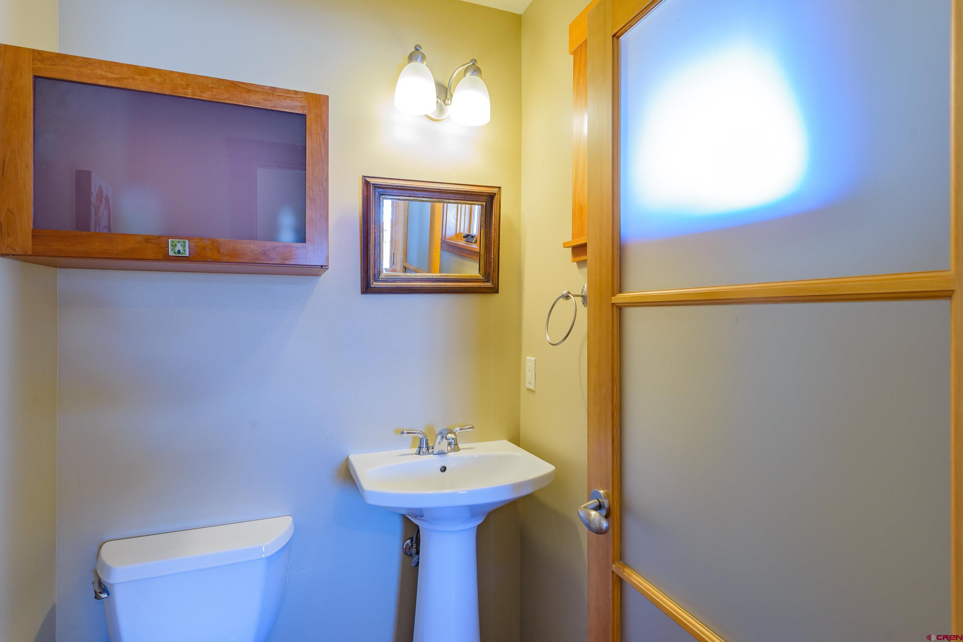 70 Bridle Spur Way Crested Butte, CO 81224 - Photo 12 of 42 a bathroom with a sink and mirror with toilet