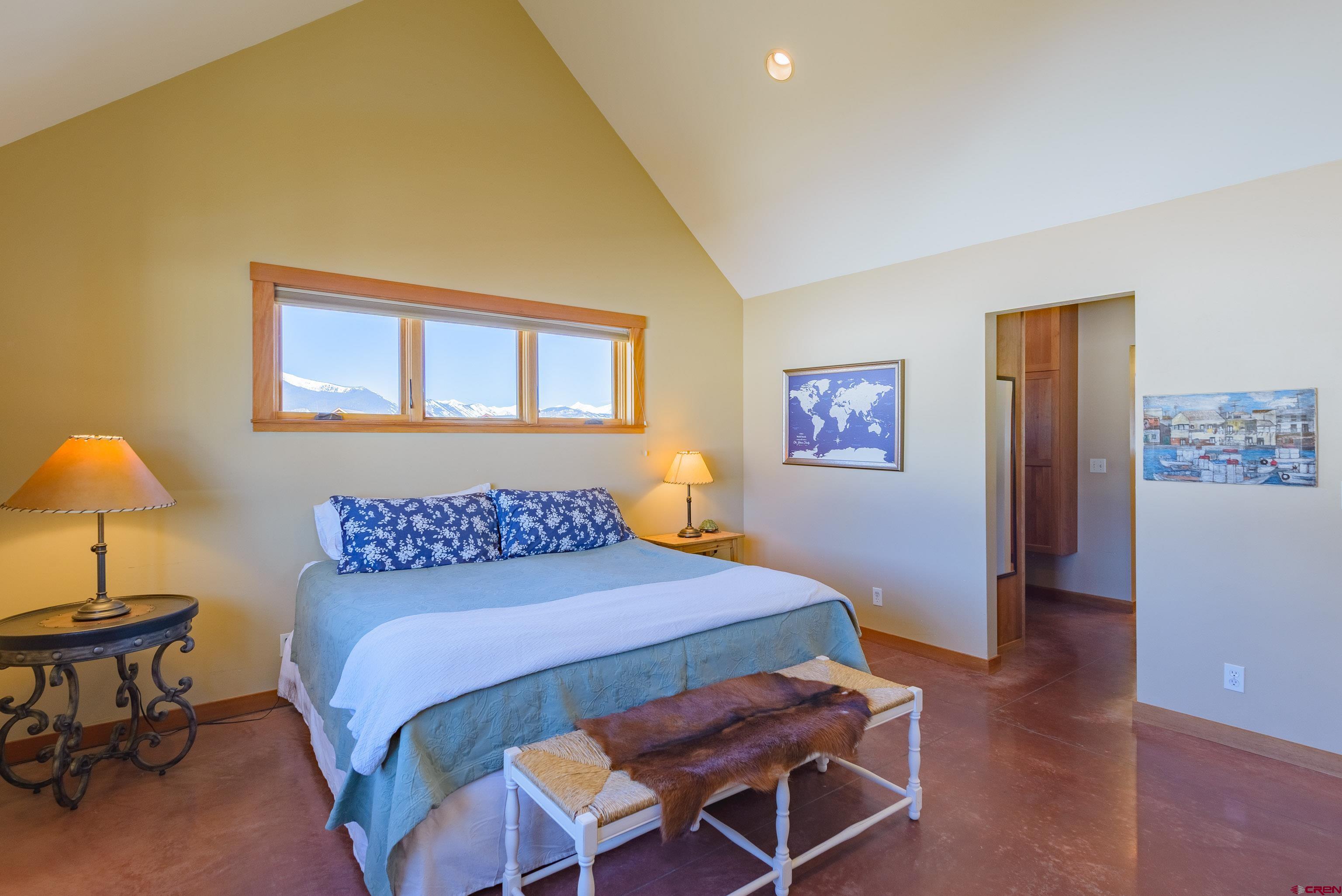 70 Bridle Spur Way Crested Butte, CO 81224 - Photo 13 of 42 a bedroom with a bed and a lamp on table
