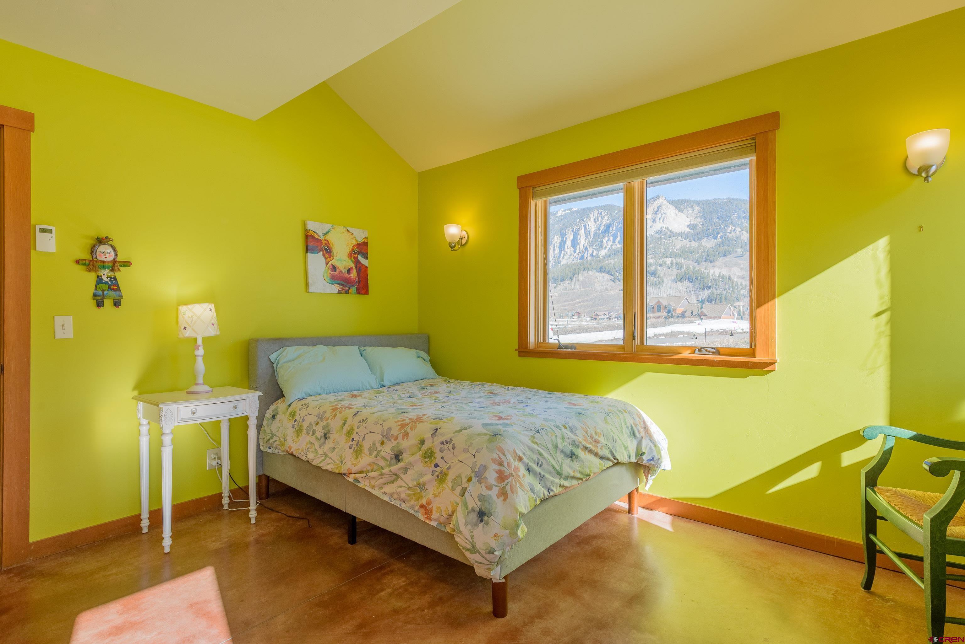 70 Bridle Spur Way Crested Butte, CO 81224 - Photo 20 of 42 a bedroom with a bed and painted walls