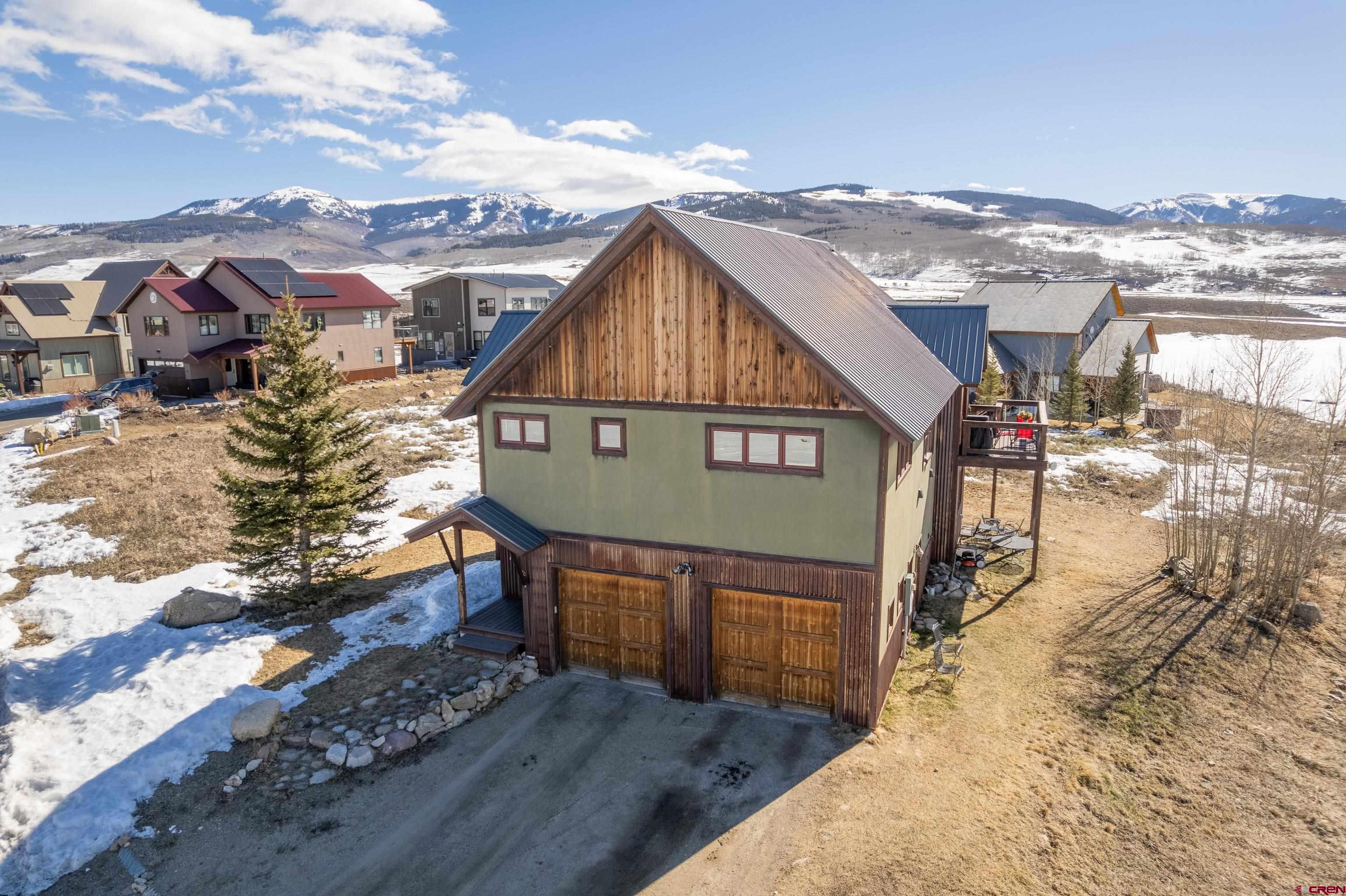 70 Bridle Spur Way Crested Butte, CO 81224 - Photo 2 of 42 a view of a house with wooden fence