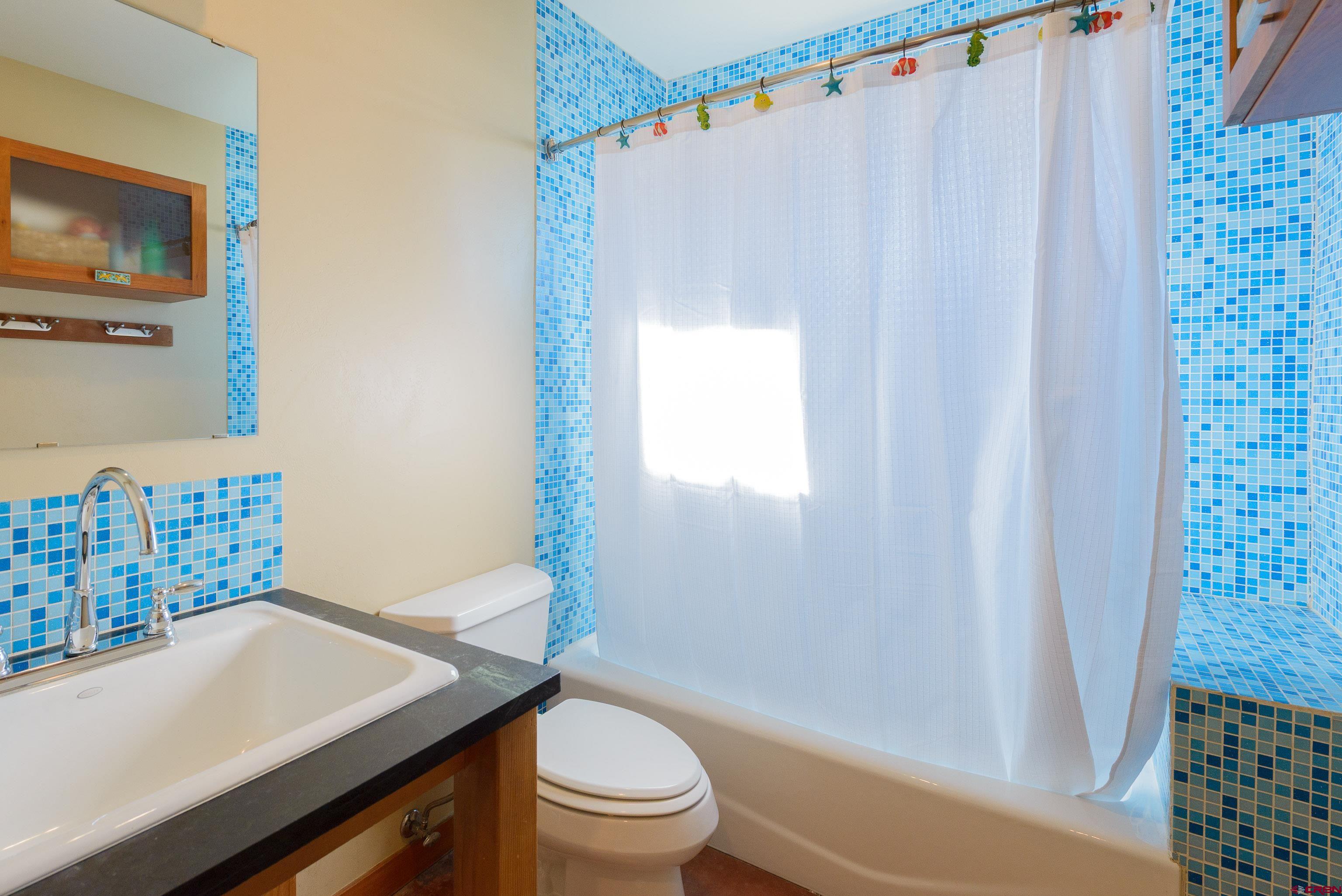 70 Bridle Spur Way Crested Butte, CO 81224 - Photo 22 of 42 a bathroom with a sink toilet and shower