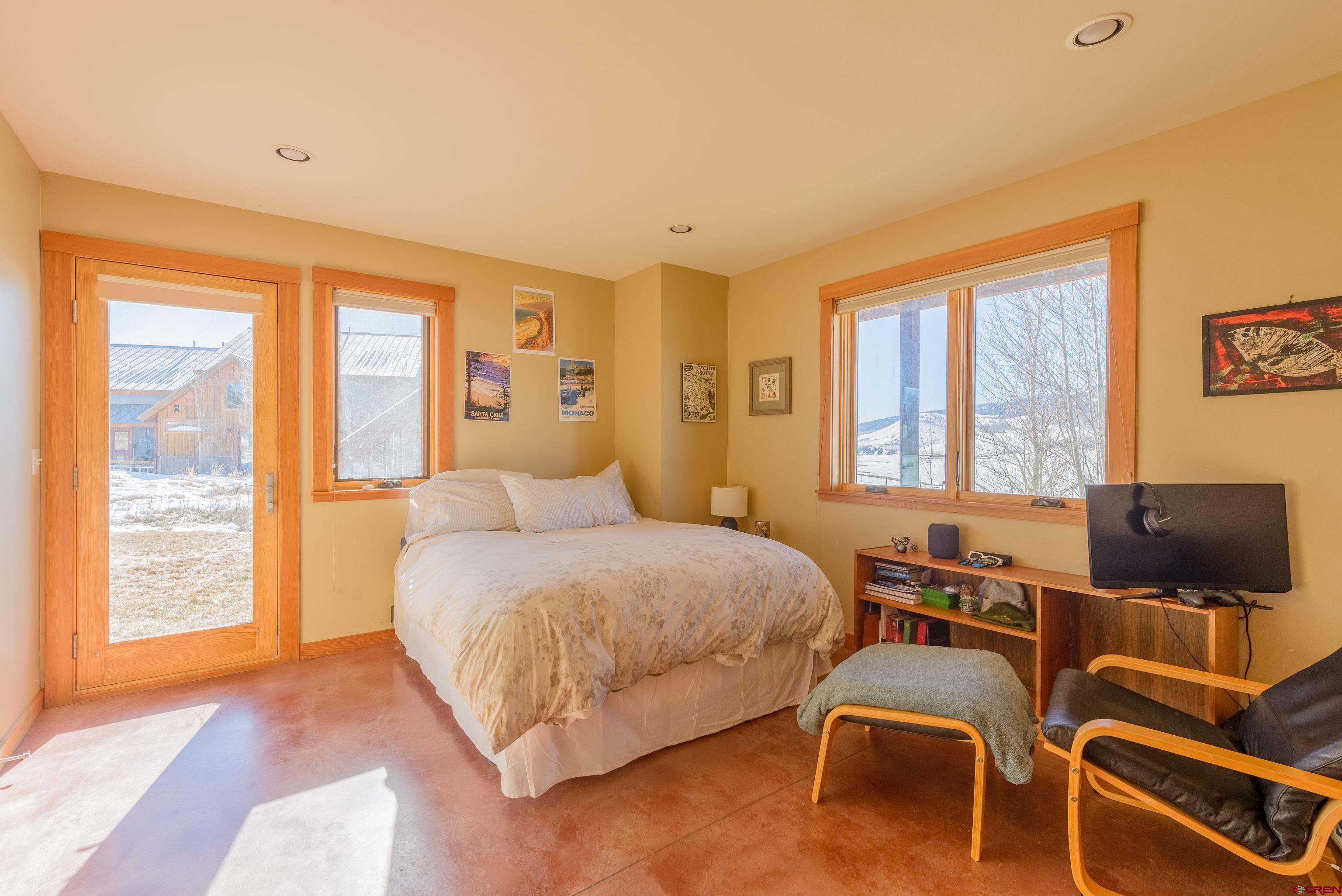 70 Bridle Spur Way Crested Butte, CO 81224 - Photo 23 of 42 a bedroom with a bed and glass window