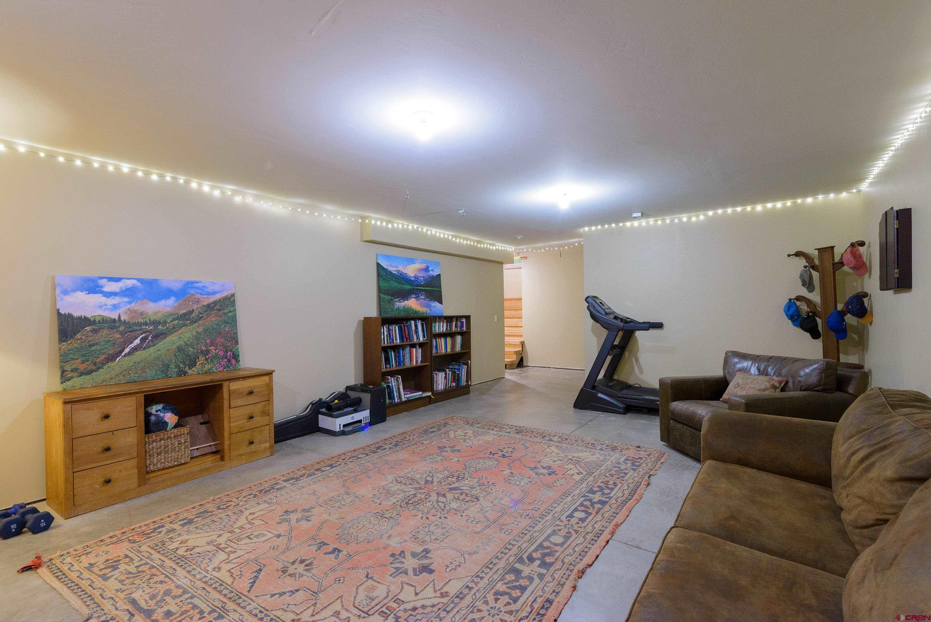 70 Bridle Spur Way Crested Butte, CO 81224 - Photo 26 of 42 a living room with furniture and a flat screen tv