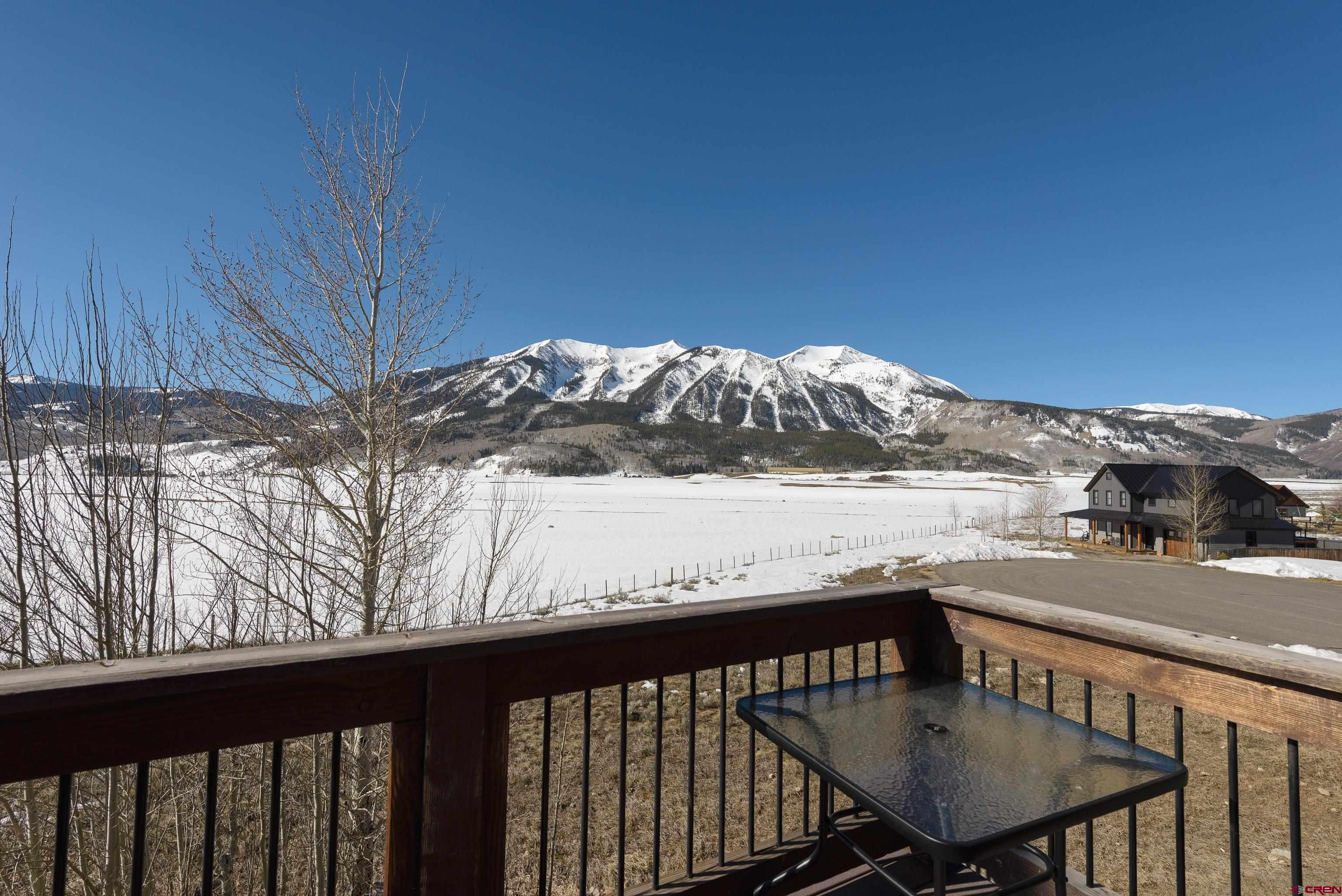 70 Bridle Spur Way Crested Butte, CO 81224 - Photo 28 of 42 a view of a balcony with chair and wooden floor