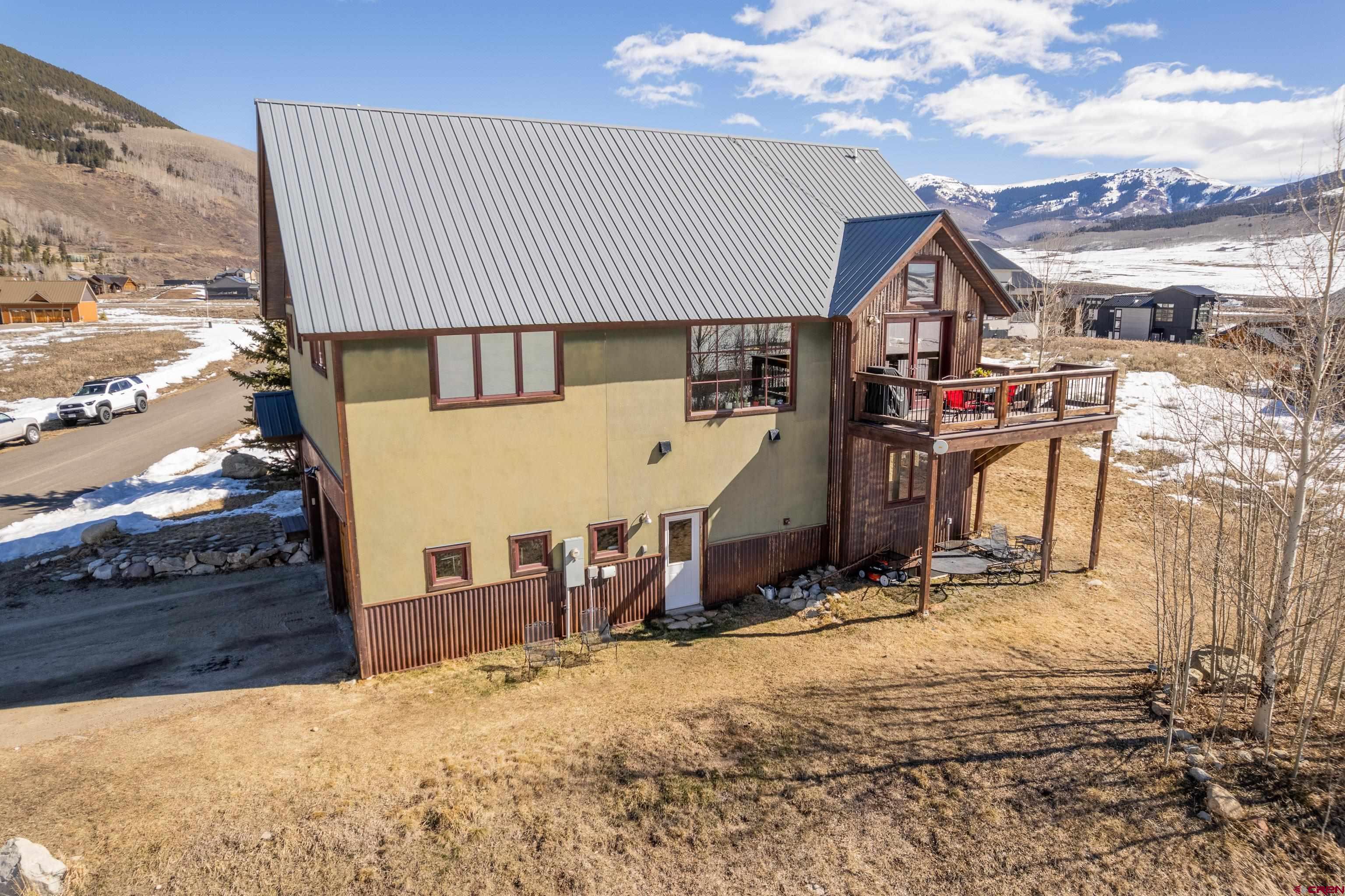 70 Bridle Spur Way Crested Butte, CO 81224 - Photo 3 of 42 a view of a house with wooden fence