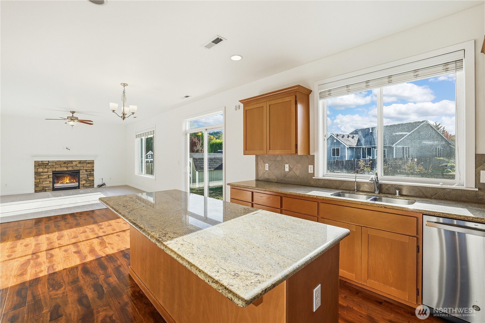 114 Ames Street Northeast Orting, WA 98360 - Photo 11 of 38 a large kitchen with granite countertop a stove a sink and a counter space