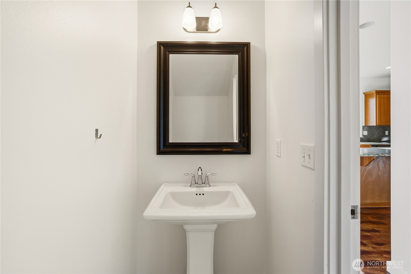 114 Ames Street Northeast Orting, WA 98360 - Photo 12 of 38 a bathroom with a sink and a mirror