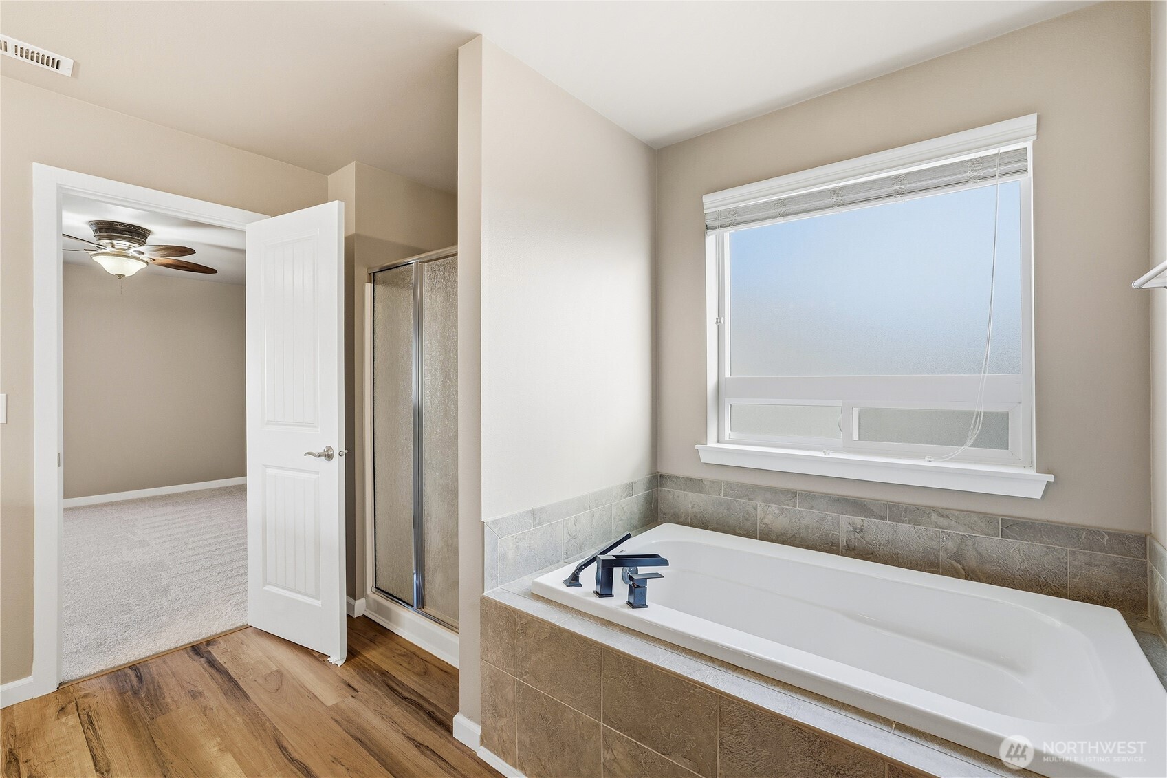 114 Ames Street Northeast Orting, WA 98360 - Photo 18 of 38 a bathroom with a tub a window and a rug