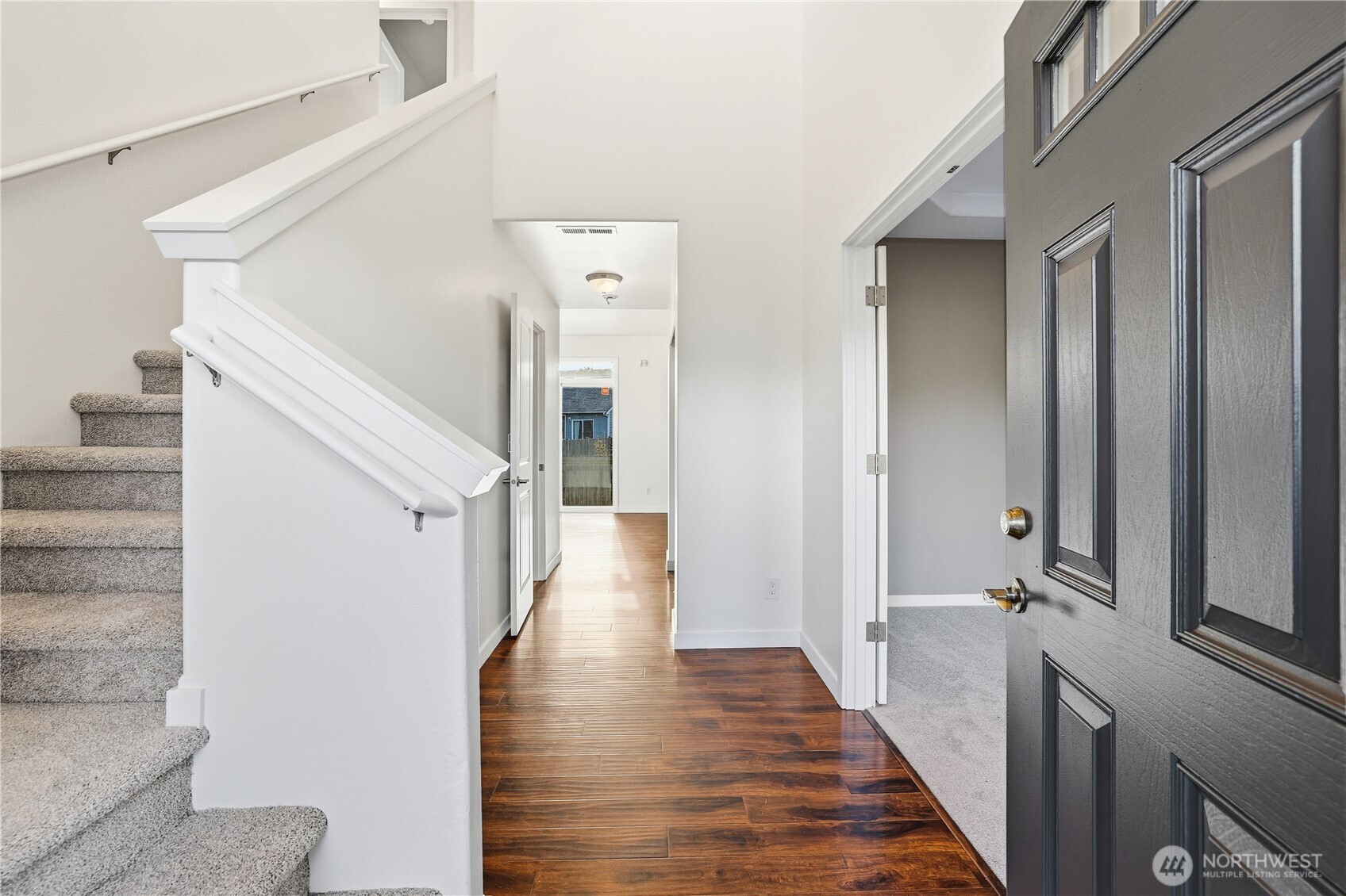 114 Ames Street Northeast Orting, WA 98360 - Photo 2 of 38 a view of a hallway with a wooden floor and entryway