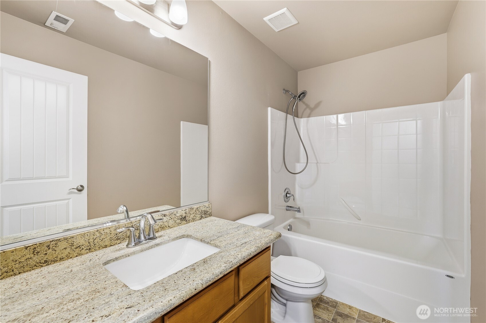 114 Ames Street Northeast Orting, WA 98360 - Photo 23 of 38 a bathroom with a granite countertop sink a toilet and shower