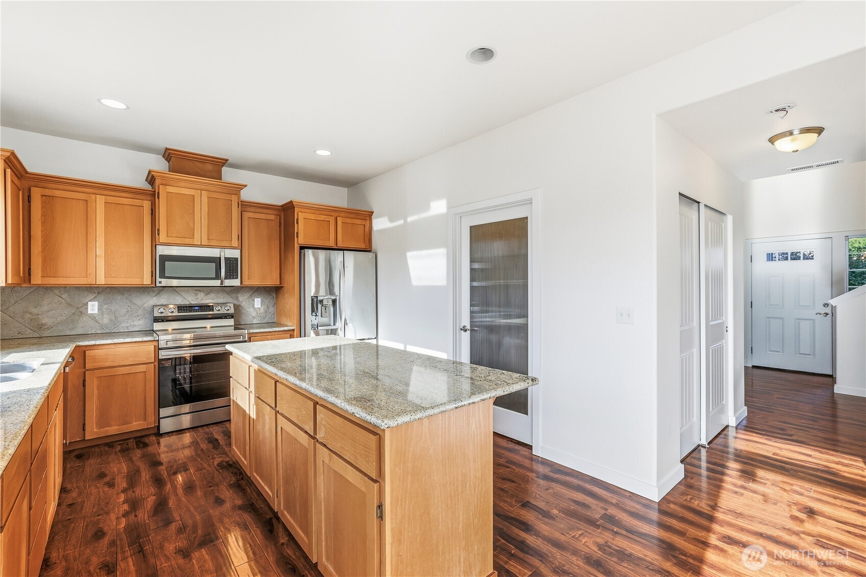 114 Ames Street Northeast Orting, WA 98360 - Photo 9 of 38 a kitchen with stainless steel appliances granite countertop a sink stove and refrigerator