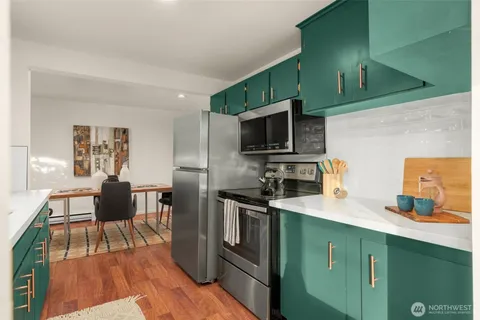 a kitchen with a sink microwave and cabinets