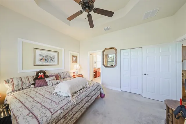 a living room with furniture a flat screen tv and a floor to ceiling window