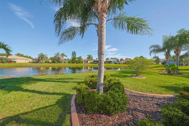 an aerial view of a house with a yard and lake view