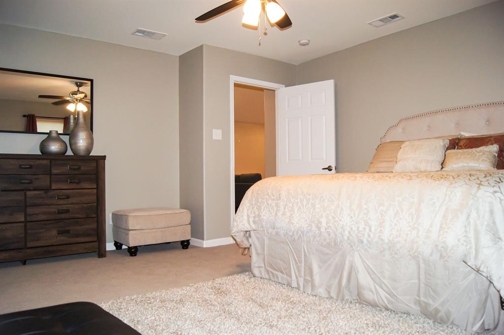 1727 Pueblo Street Dallas, TX 75212 - Photo 18 of 27 a bedroom with a bed and a cabinets