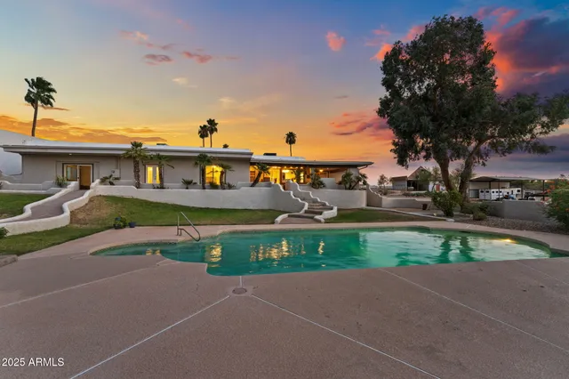 a living room with furniture a floor to ceiling window and a fireplace