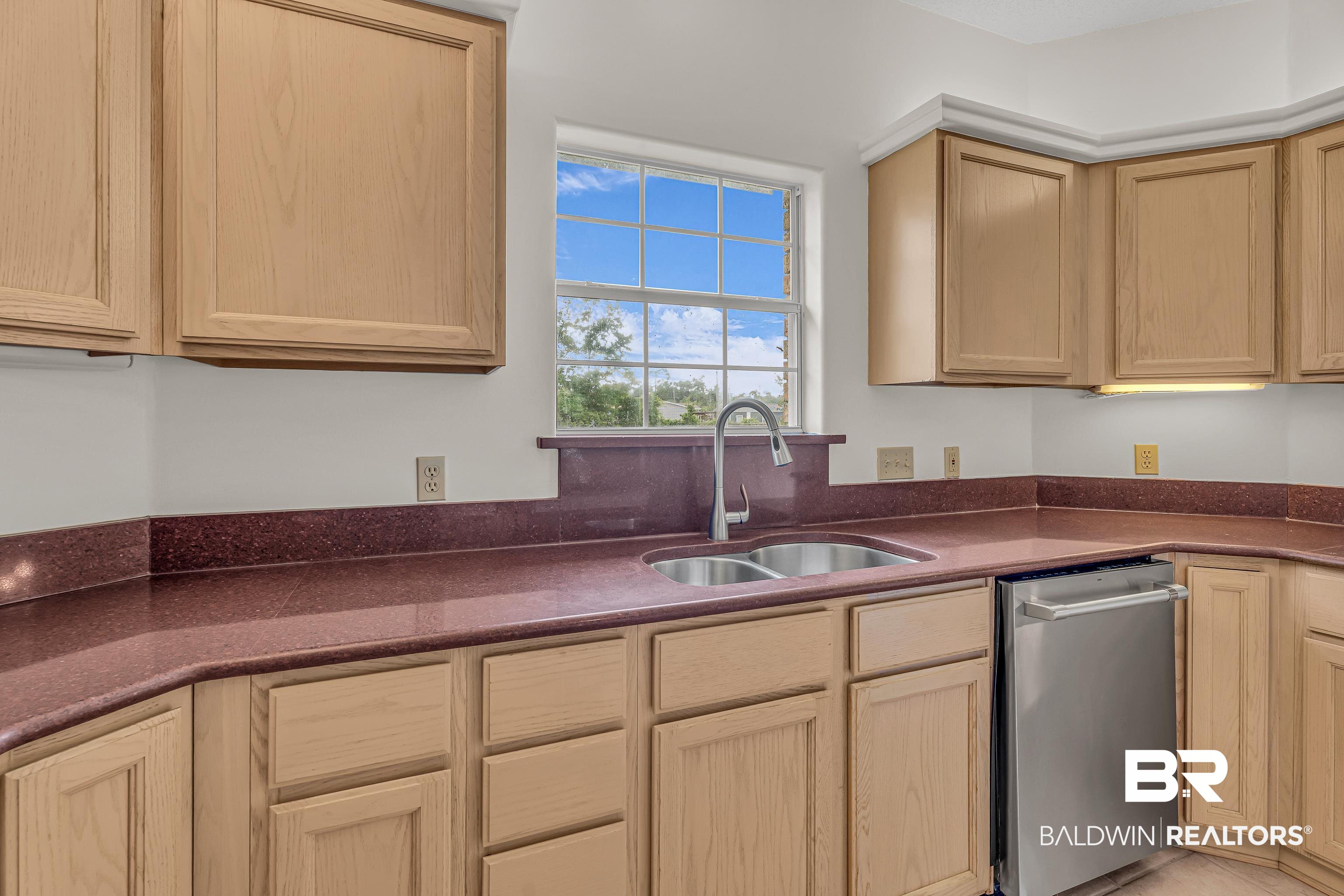 9530 Pilgrim Drive Elberta, AL 36530 - Photo 16 of 61 Kitchen featuring a sink, dishwasher, and dark countertops