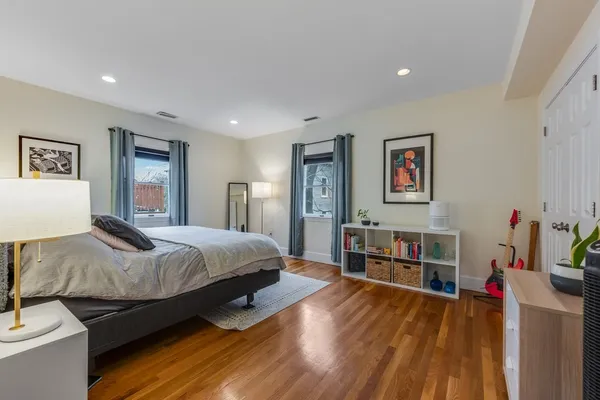 a bedroom with a bed and a view of kitchen