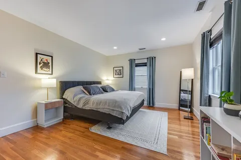 a spacious bedroom with a bed and a couch