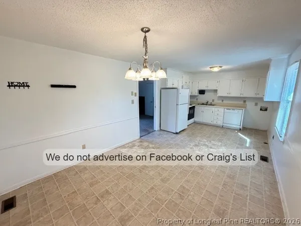 a room with a chandelier and rug