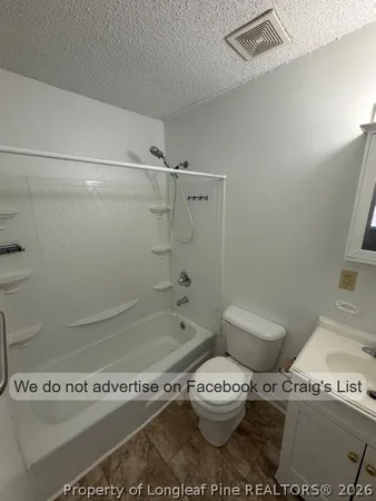 a white toilet sitting next to a bath tub