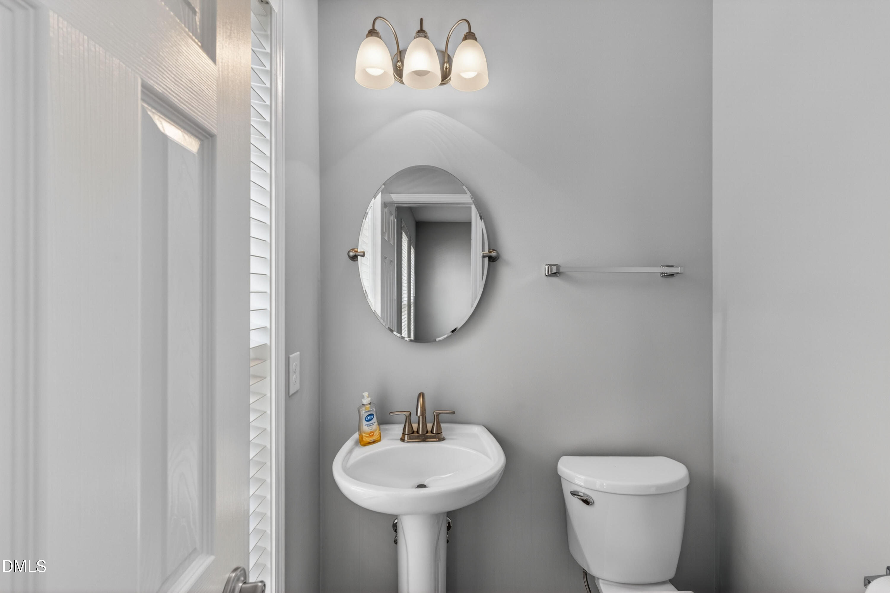 5421 Golden Arrow Lane Raleigh, NC 27613 - Photo 24 of 49 a bathroom with a toilet sink and mirror
