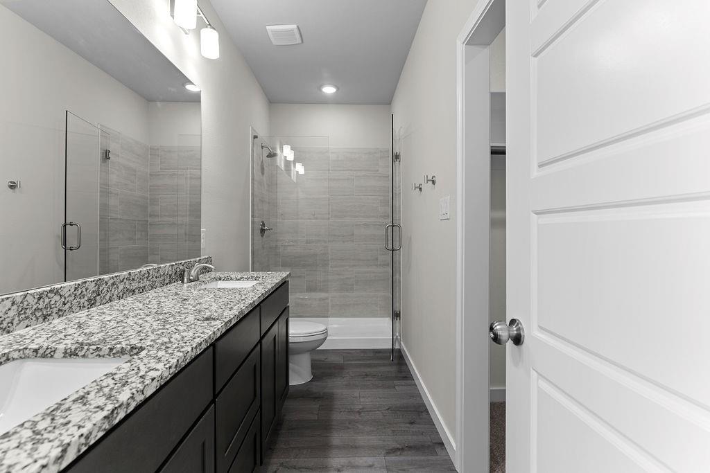 620 Alameda Road Azle, TX 76020 - Photo 19 of 27 a bathroom with a granite countertop sink and a mirror