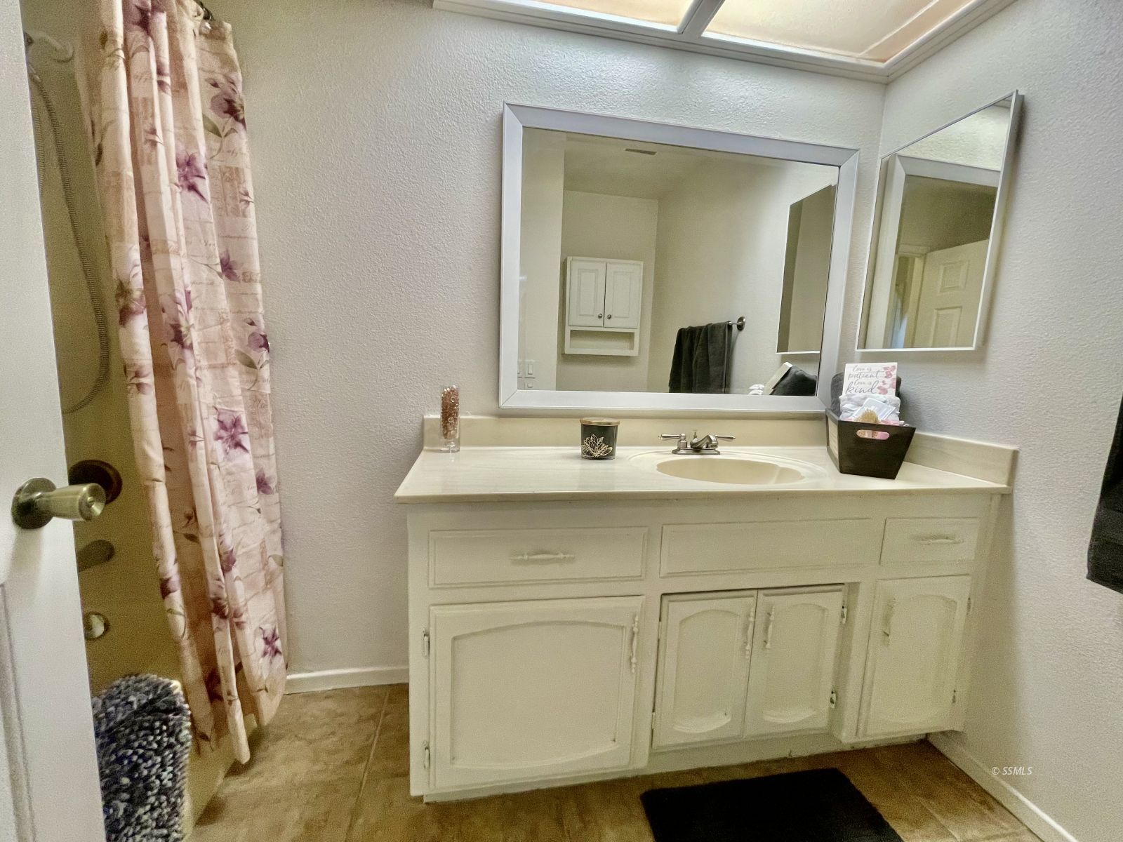 225 Michele Street Ridgecrest, CA 93555 - Photo 34 of 36 a bathroom with a sink and a mirror