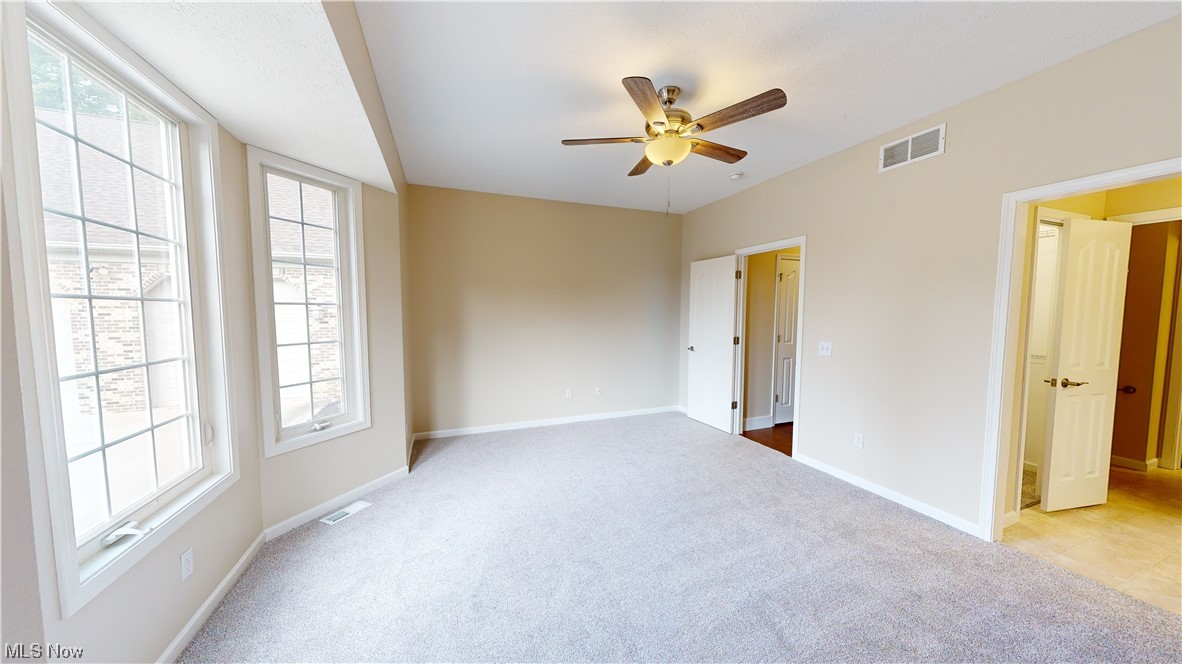8325 Munson Road Mentor, OH 44060 - Photo 22 of 35 Spare room with light carpet, a healthy amount of sunlight, and ceiling fan