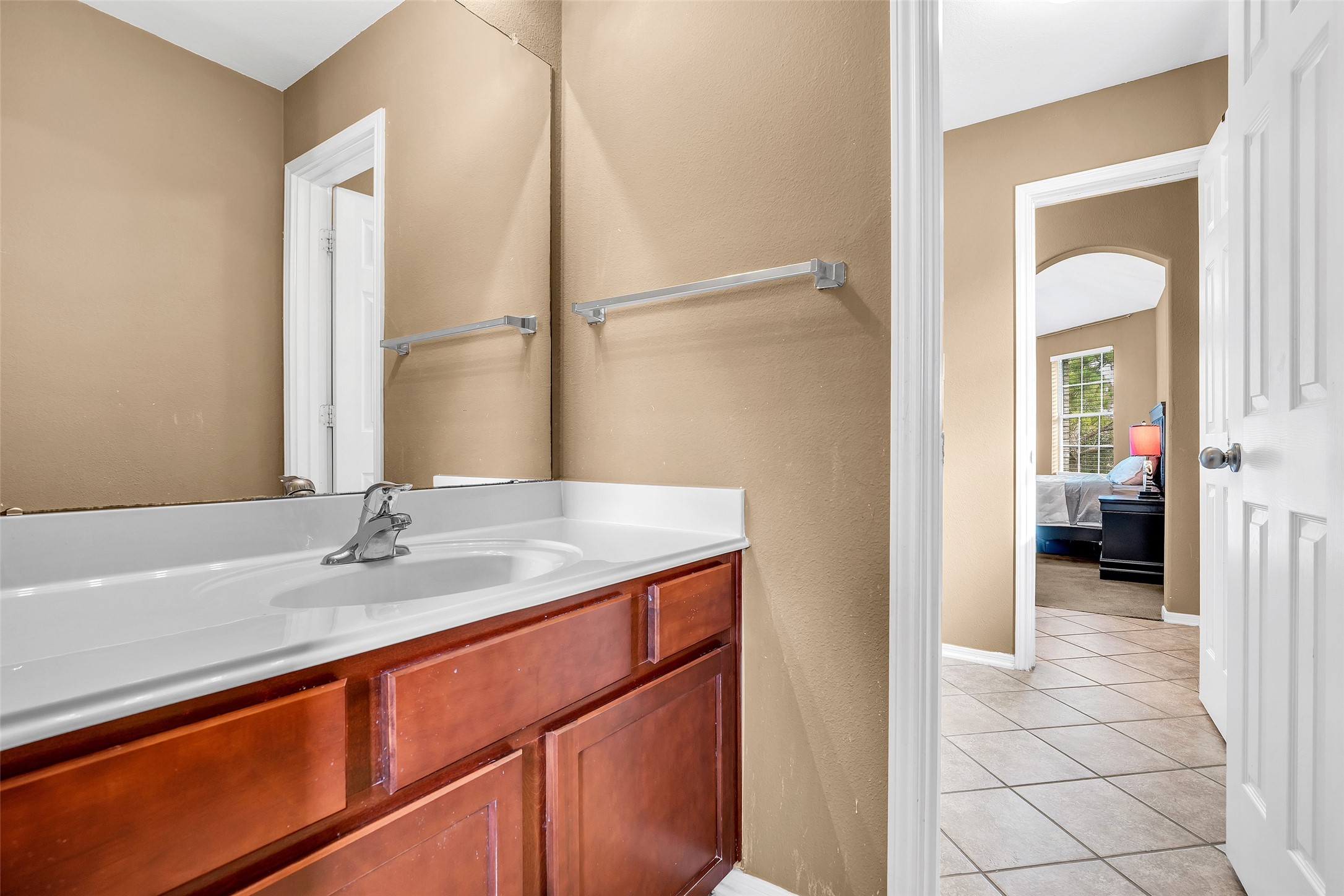 611 River Delta Lane Rosenberg, TX 77469 - Photo 33 of 39 a en suite bathroom with a granite countertop sink and a mirror
