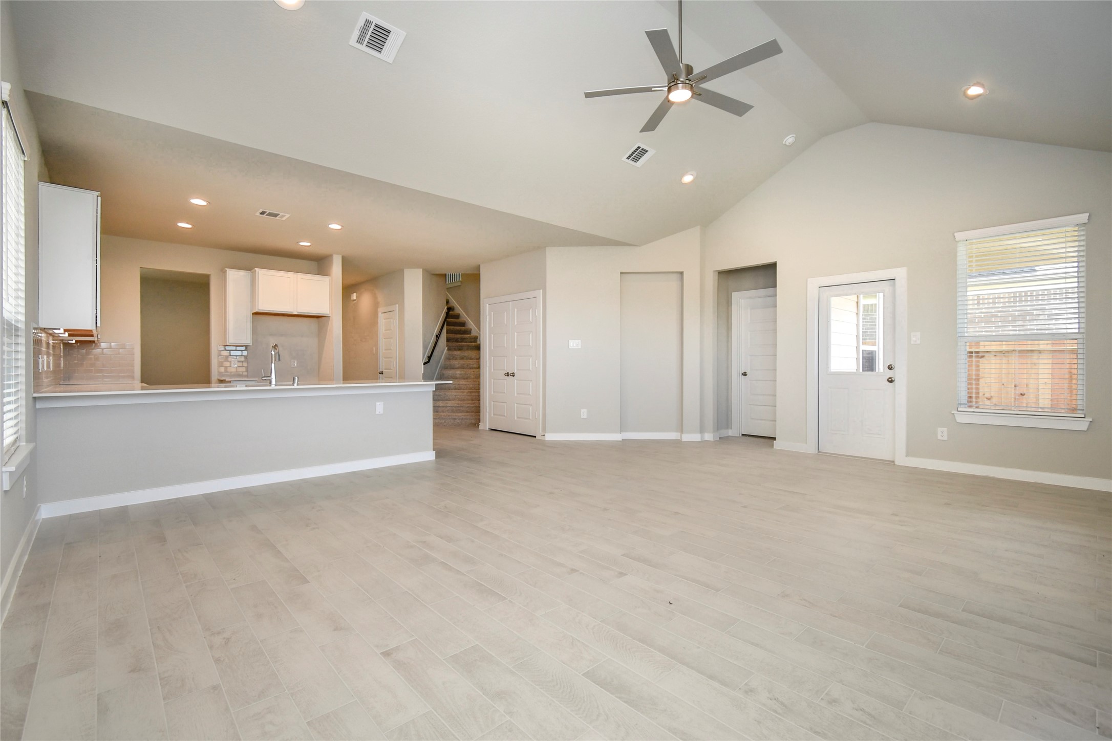 15203 Statice Trail Houston, TX 77044 - Photo 13 of 21 an empty room with large windows and ceiling fan