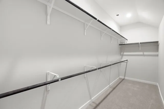 an empty room with windows and cabinet