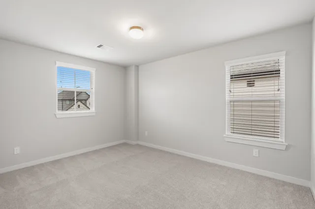 a view of a swimming pool with a garden and plants