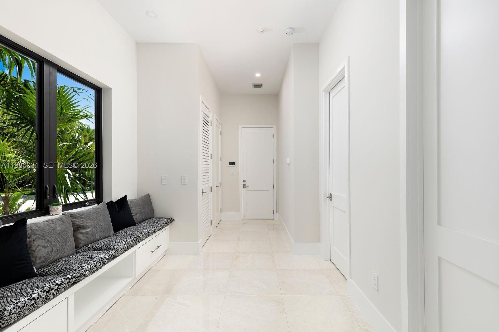 6065 Southwest 109th Street Pinecrest, FL 33156 - Photo 13 of 28 a living room with furniture and large windows