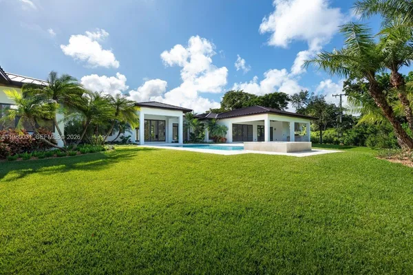 a front view of house with yard and green space