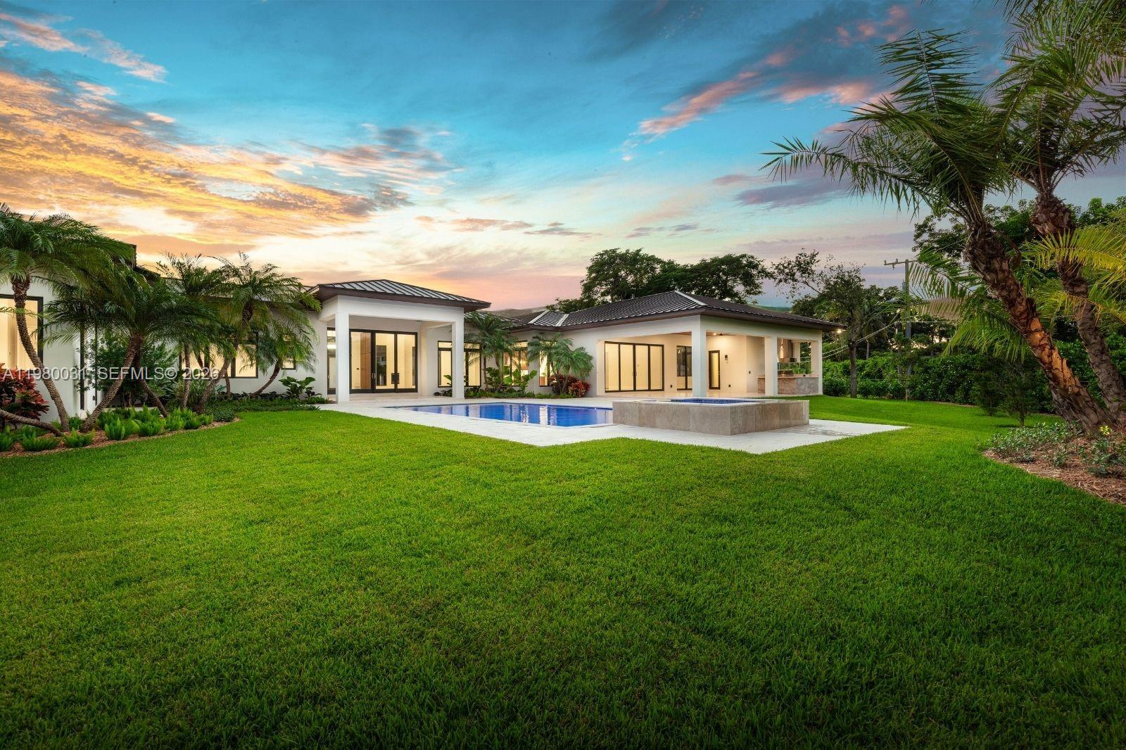 6065 Southwest 109th Street Pinecrest, FL 33156 - Photo 22 of 28 a front view of house with yard and green space