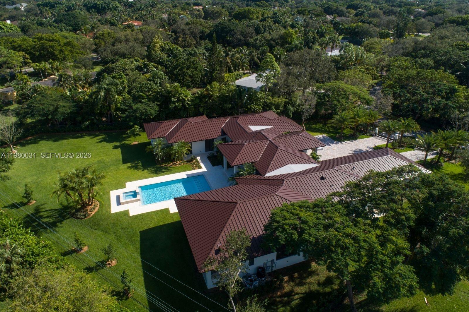6065 Southwest 109th Street Pinecrest, FL 33156 - Photo 24 of 28 an aerial view of a house with garden space sitting space and garden