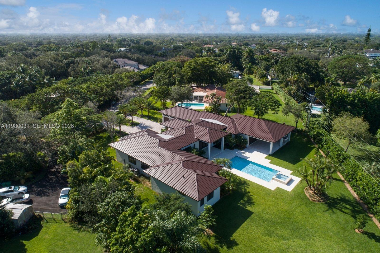 6065 Southwest 109th Street Pinecrest, FL 33156 - Photo 25 of 28 an aerial view of a house with a garden