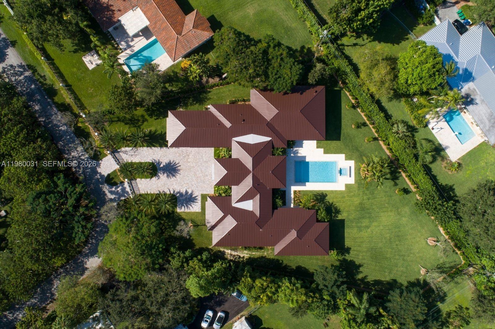 6065 Southwest 109th Street Pinecrest, FL 33156 - Photo 26 of 28 an aerial view of a house with garden space and street view