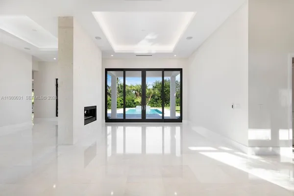 a bedroom with furniture and a large window