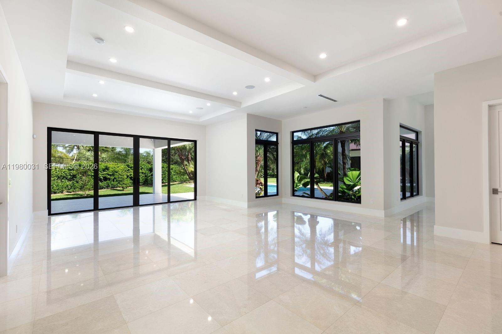 6065 Southwest 109th Street Pinecrest, FL 33156 - Photo 6 of 28 a view of an entryway with floor to ceiling windows