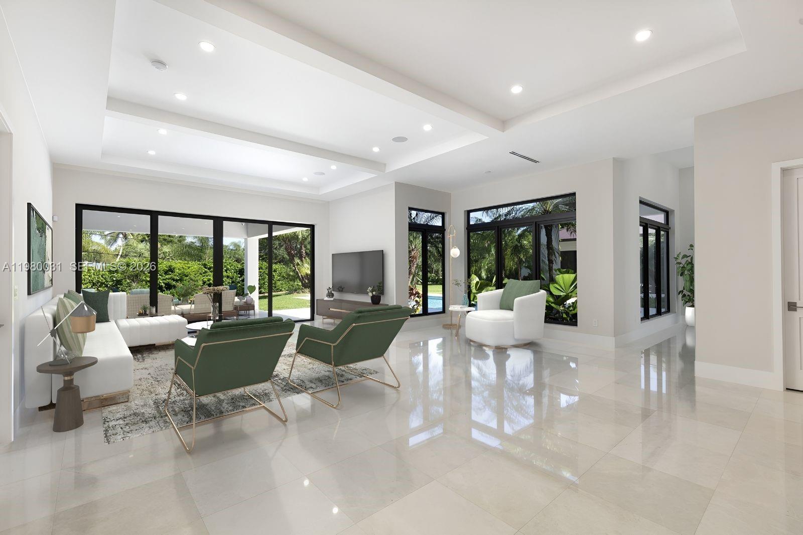 6065 Southwest 109th Street Pinecrest, FL 33156 - Photo 7 of 28 a living room with furniture large windows and wooden floor